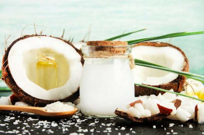 кокосовое масло использует банку кокосового масла с декоративным дисплеем из половинок кокоса и кусочков кокоса