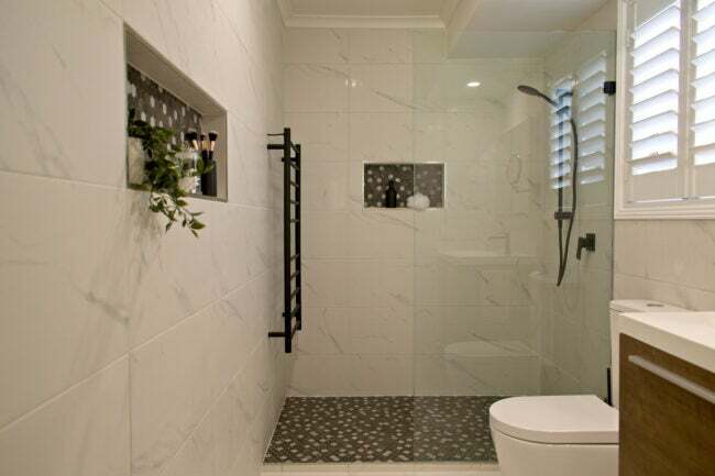 Розкішна окрема ванна кімната з душовими полицями